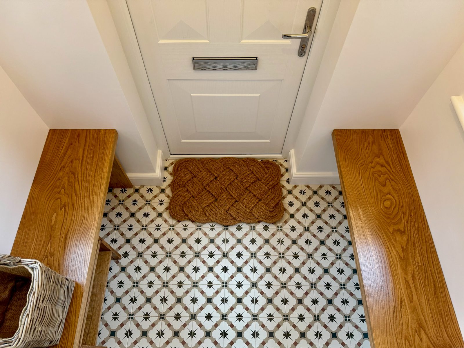 Finished patterned floor tiles at the entrance to a customer's porch